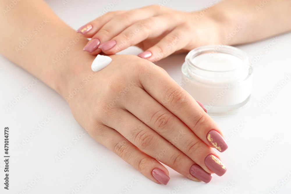 Fototapeta premium Concept of hand care with cosmetics on white background