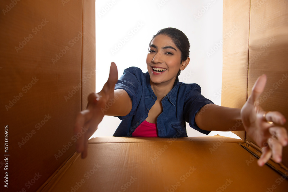 Adult girl posing in front of camera through cardboard boxes Stock ...