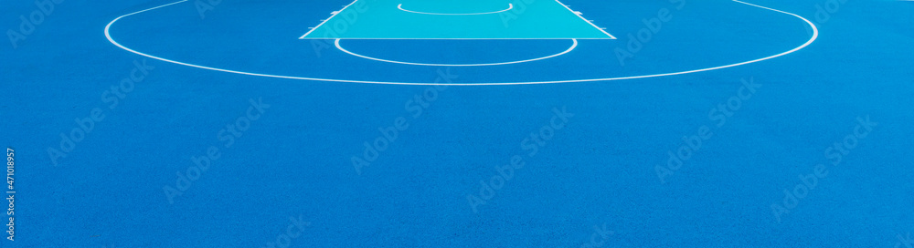 Blue background of newly made outdoor basketball court. Visible asphalt texture, freshly painted white lines. Horizontal sport theme poster, greeting cards, headers, website and app