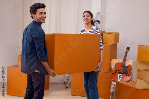 Adult boy and girl moving carton box house shifting photo