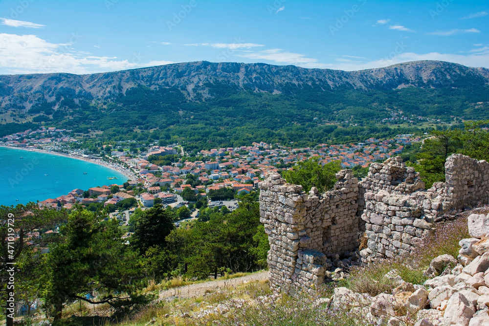 Obraz premium The ruins of the medieval Baska Citadel, Kastel Baska, overlooking the south Krk island town of Baska in the Primorje-Gorski Kotar County of western Croatia 