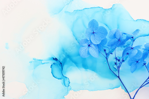 Creative image of blue Hydrangea flowers on artistic ink background. Top view with copy space