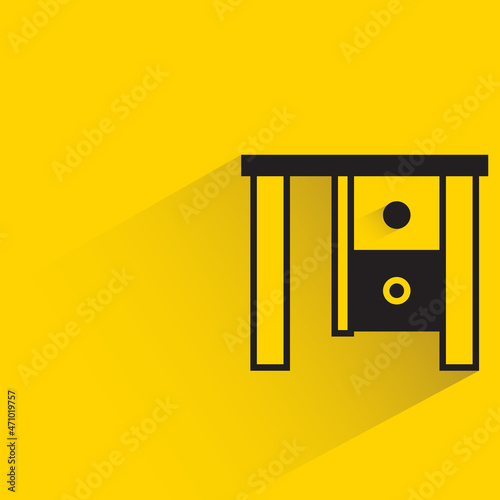 office table with shadown on yellow background photo