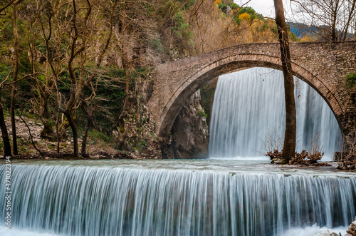 Historical stone bridge of Palaiokarya with its two artificial waterfalls situated close to Trikala and Meteora. photo