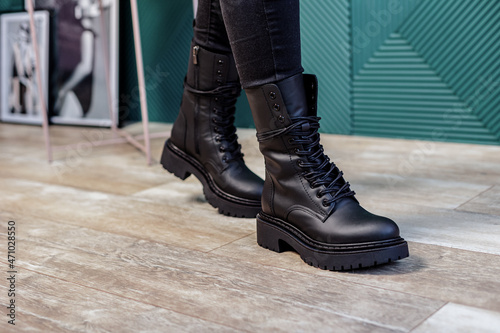 Close up of black womens boots. Fashionable women's stylish leather boots.