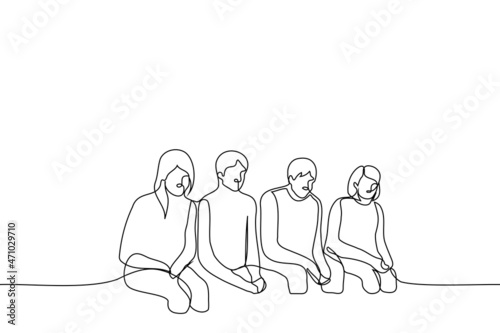 group of young men and women guiltily sitting in a row with their heads bowed - one line drawing vector. the concept of obedience, submission, guilty students, failed group work