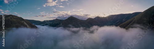 Cloudy morning, fog over river at sunset