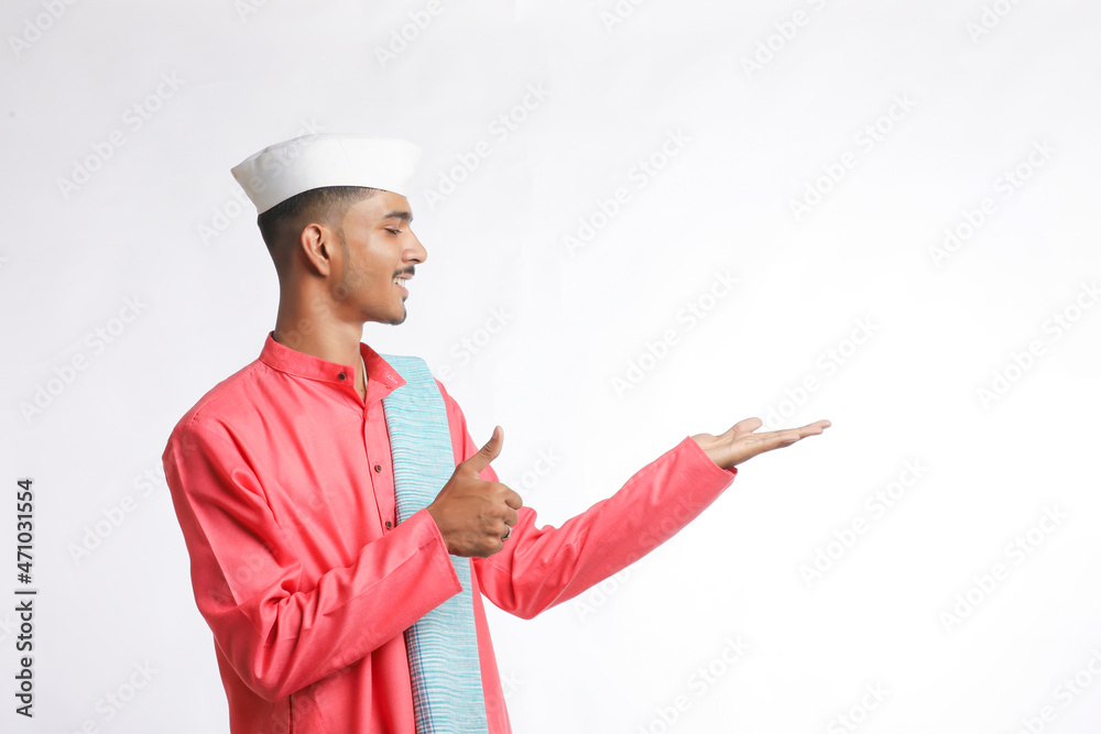 young indian man in traditional wear and showing expression on white background young indian man in traditional wear and showing expression on white background