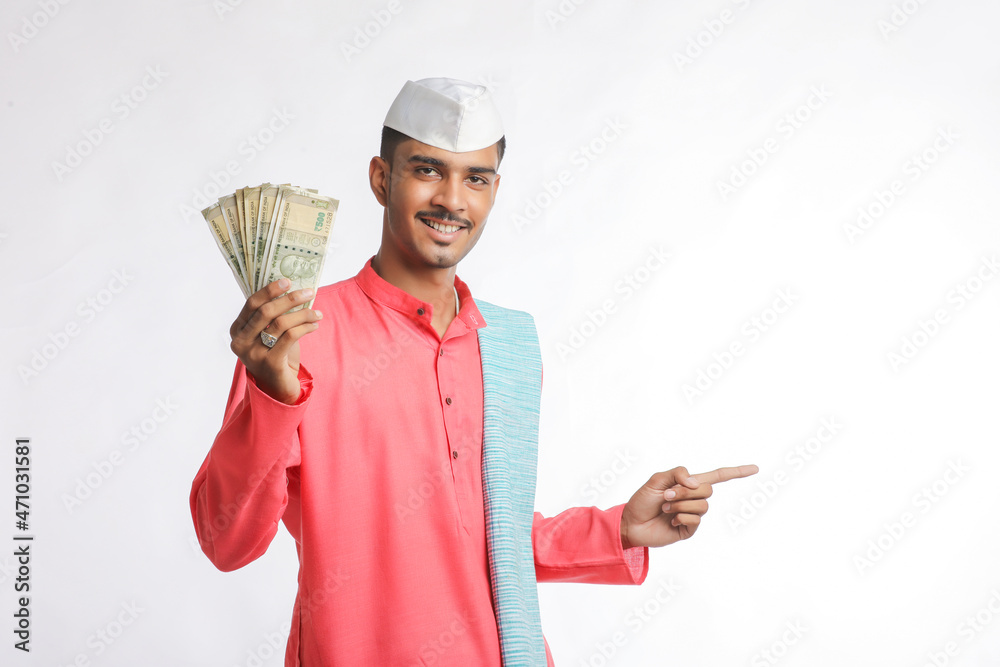 Young indian farmer showing money on white background. Young indian farmer showing money on white background.