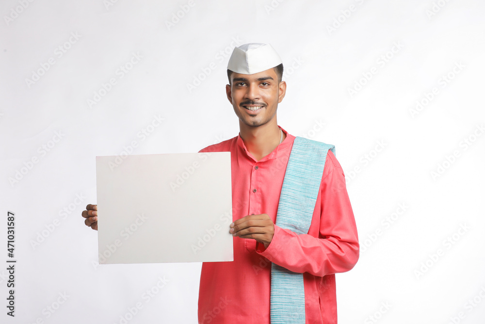 Young indian farmer holding white card board on white background. Young indian farmer holding white card board on white background.