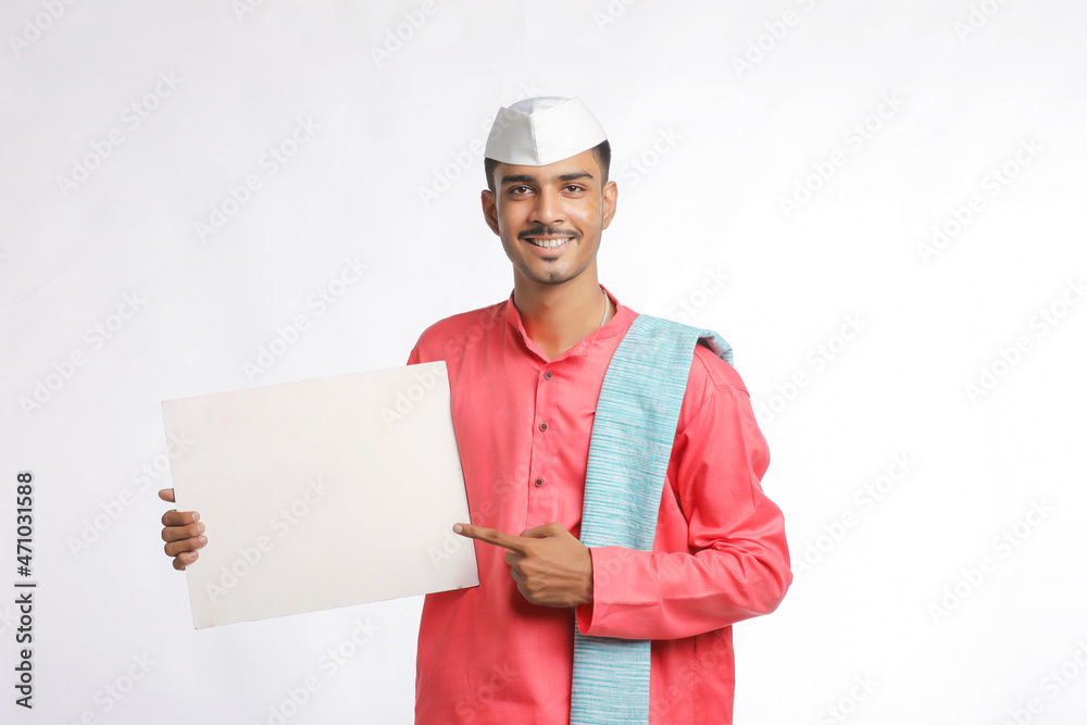 Young indian farmer holding white card board on white background. Young indian farmer holding white card board on white background.