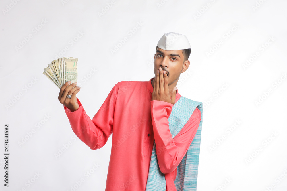 Young indian farmer showing money on white background. Young indian farmer showing money on white background.