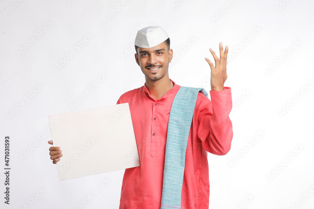 Young indian farmer holding white card board on white background. Young indian farmer holding white card board on white background.