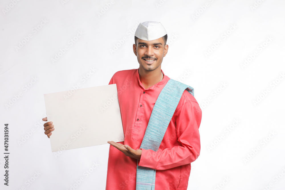 Young indian farmer holding white card board on white background. Young indian farmer holding white card board on white background.