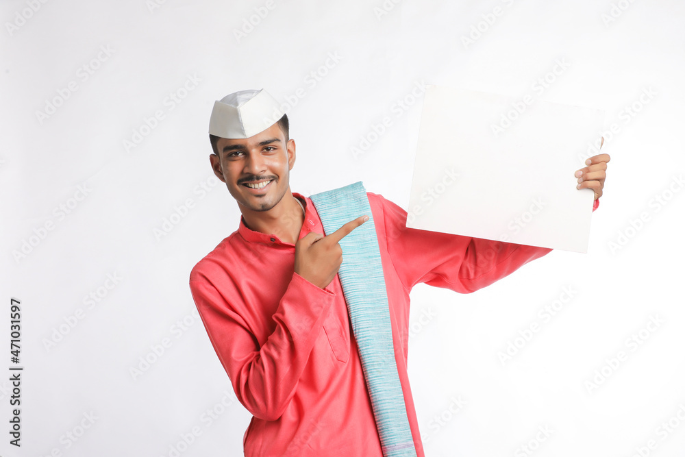 Young indian farmer holding white card board on white background. Young indian farmer holding white card board on white background.