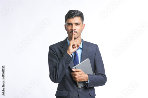 Young indian man in suit and giving expression on white background