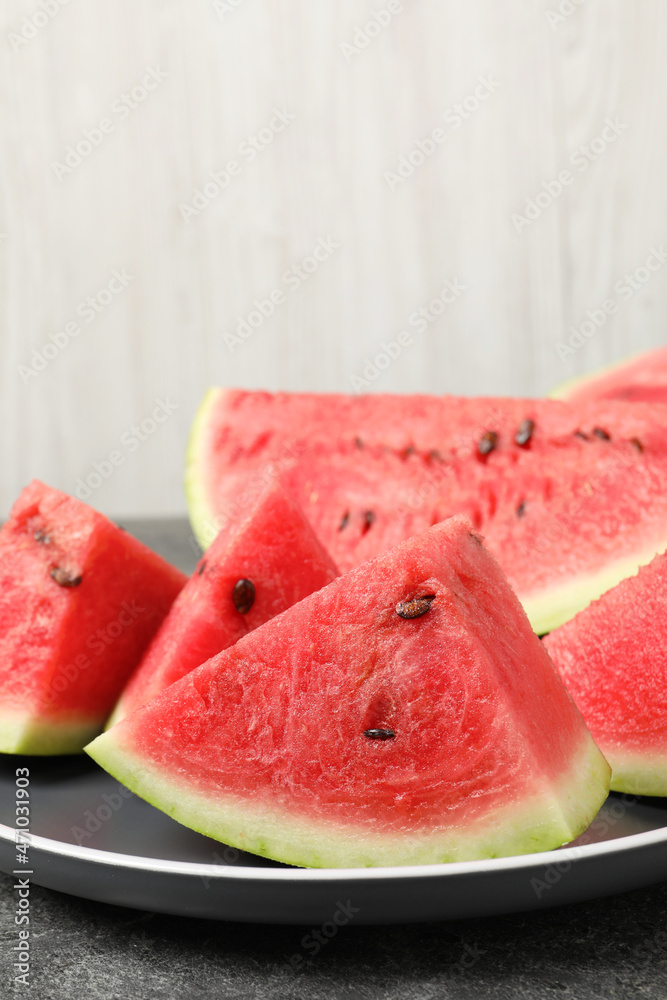 Delicious fresh watermelon slices on grey table, closeup