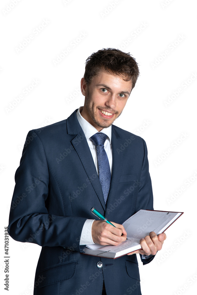 Portrait of handsome young businessman holding diary on a white background. Holds a notebook and writes information, tasks, reminders. He is wearing elegant suit. Portrait of handsome young businessman holding diary on a white background. Holds a notebook and writes information, tasks, reminders. He is wearing elegant suit.