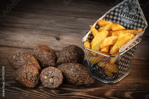 Traditional kebbe and pita bread on big round plate in lebanese restaurant. High quality photo photo