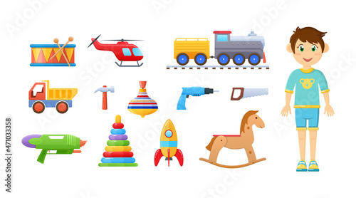 Happy child boy with childish toy set. Children playthings drum, railway, train, helicopter, truck