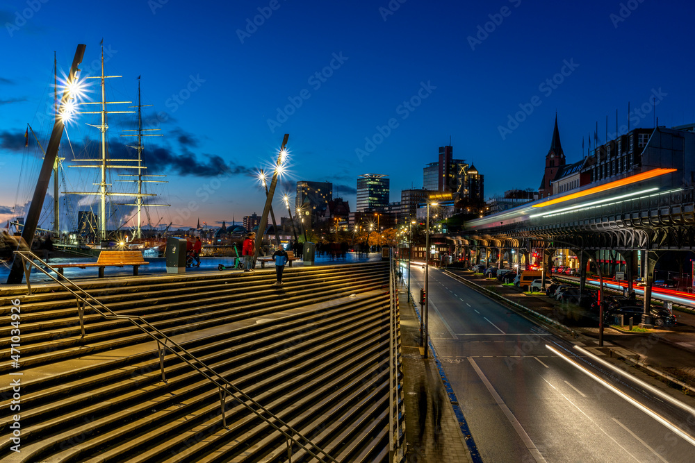 Blue hour in the port of Hamburg with stairs and traffic in motion on a nearby cloudless evening