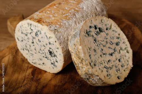 Blue Cheese - Fourme d'Ambert - on wooden background