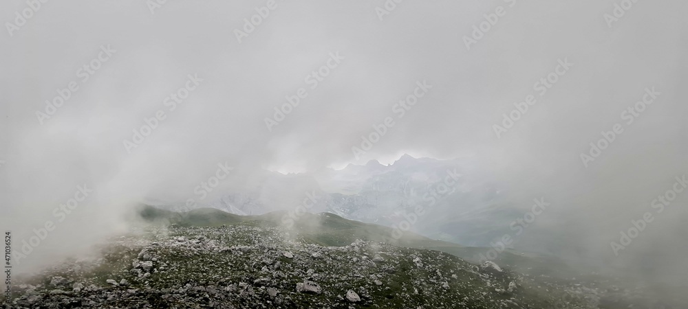Mountain panorama in the fog in the Ratikon Alps during a hike across Austria and Switzerland.