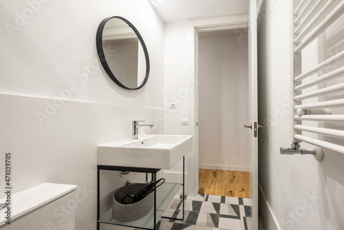 Modern design shower toilet in white  black and gray colors with round mirror and white wall mounted radiator