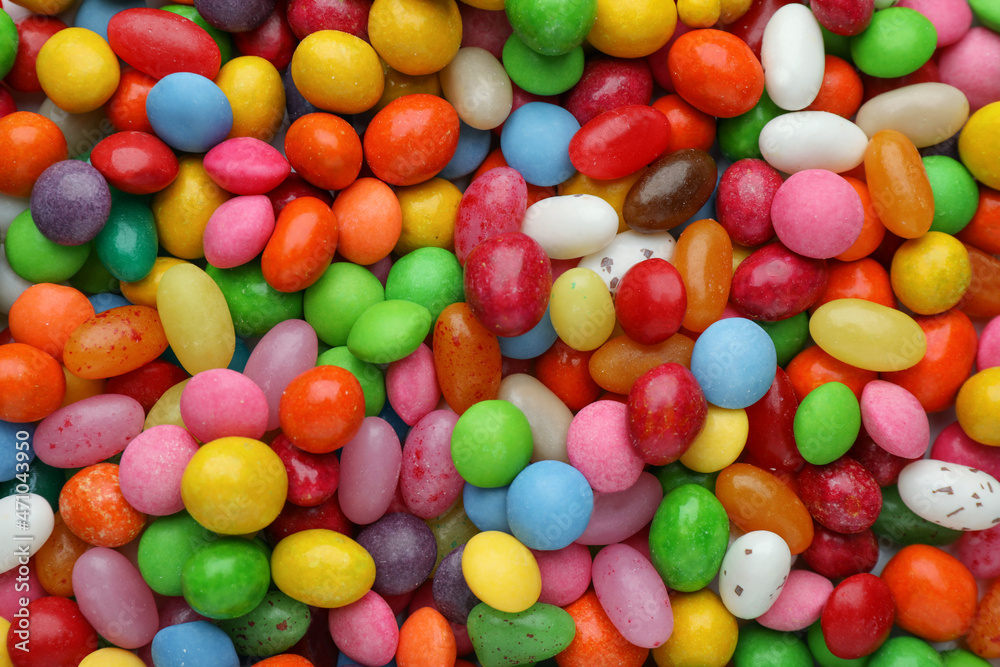 Many tasty colorful dragee candies as background, top view Many tasty colorful dragee candies as background, top view