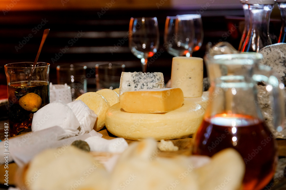 Different sorts of cheese on wooden table. Homemade chees. Assortment of different cheese types. Cheese background. Different sorts of cheese on wooden table. Homemade chees. Assortment of different cheese types. Cheese background.