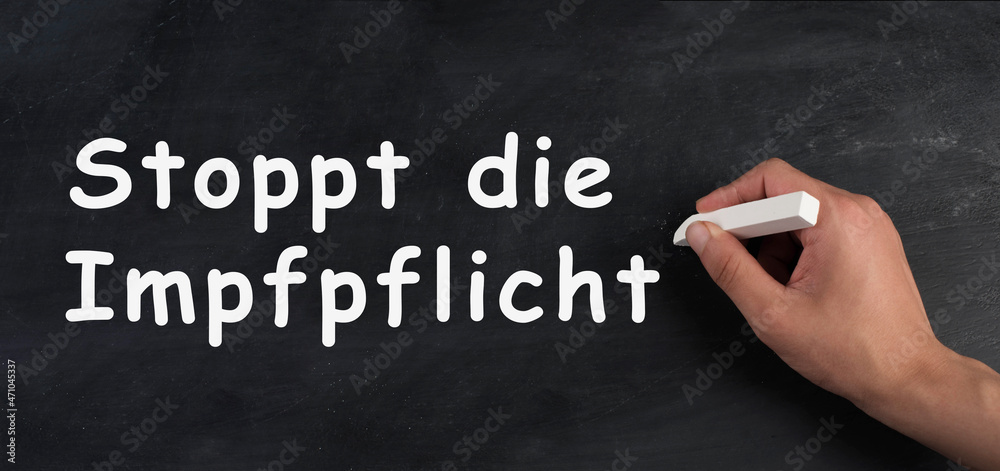 Stop mandatory vaccination is standing in german language on a chalkboard, covid-19 regulations Stop mandatory vaccination is standing in german language on a chalkboard, covid-19 regulations