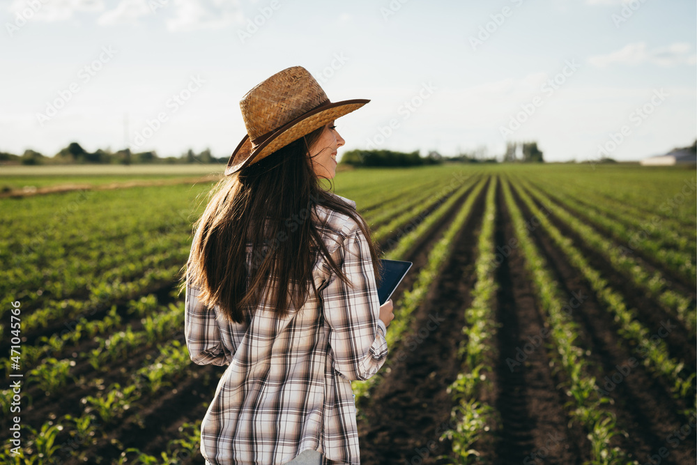 woman farmer walking on corn field