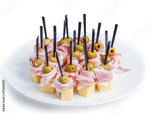 many multi-colored canapes arranged on a plate
canapes in a white torch on a white foyer photo