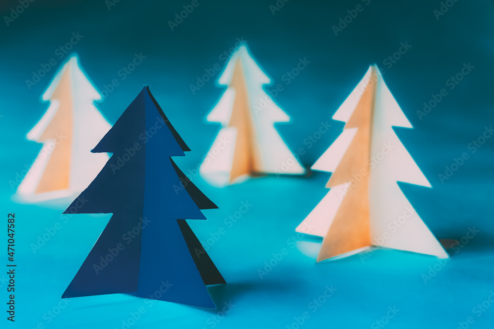 Eco Concept Christmas Trees Made From Paper. Winter Holiday Card. Simple Minimalist Paper Decoration. One Of Pine Trees Painted In Classic Blue Color. Hand Crafted Paper Pines Woods Trees. Eco Concept