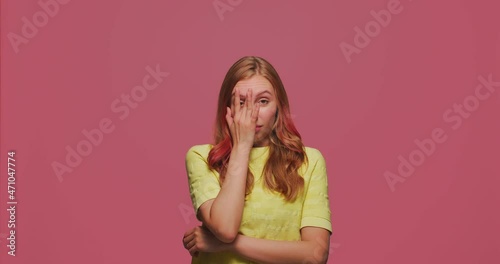 Facepalm gesture. Upset young girl slapping hand on face expressing shame about loss, failure, shaking head