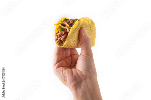 Hand holding traditional Mexican tacos with meat and vegetables isolated on white background