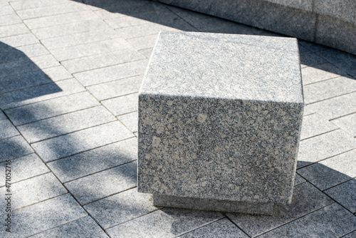 Concrete granite bench seats outside in front of the office complex 