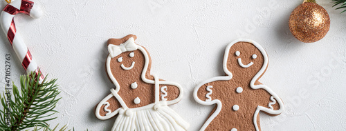 Decorated Christmas gingerbread cookies with decorations on white table background.