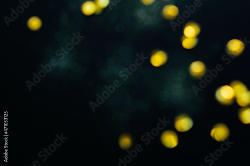 Festive abstract background, sparkling yellow and green bokeh. Copy space
