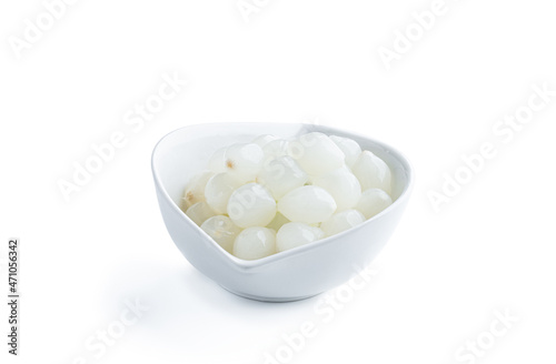 Pickled mini baby onions in white saucer isolated on white
