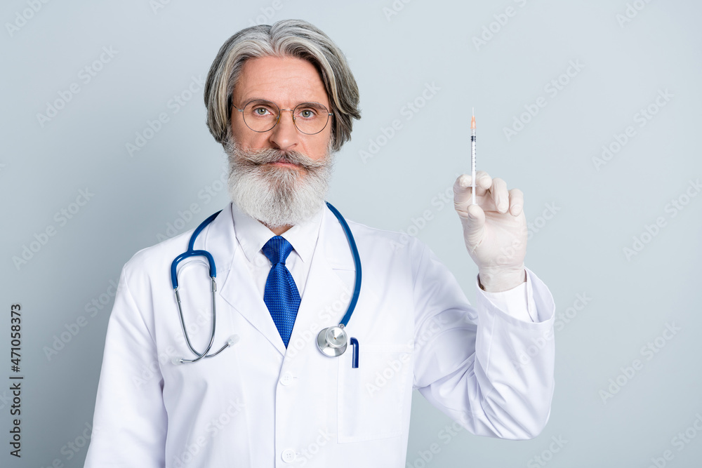 Photo of mature man cardiologist physician injection lab clinic treatment isolated over grey color background Photo of mature man cardiologist physician injection lab clinic treatment isolated over grey color background
