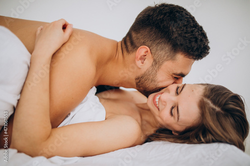 Young couple together lying in bed