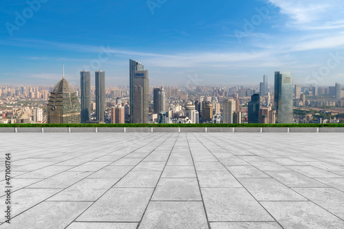 Fototapeta Naklejka Na Ścianę i Meble -  Empty brick floor with city skyline background