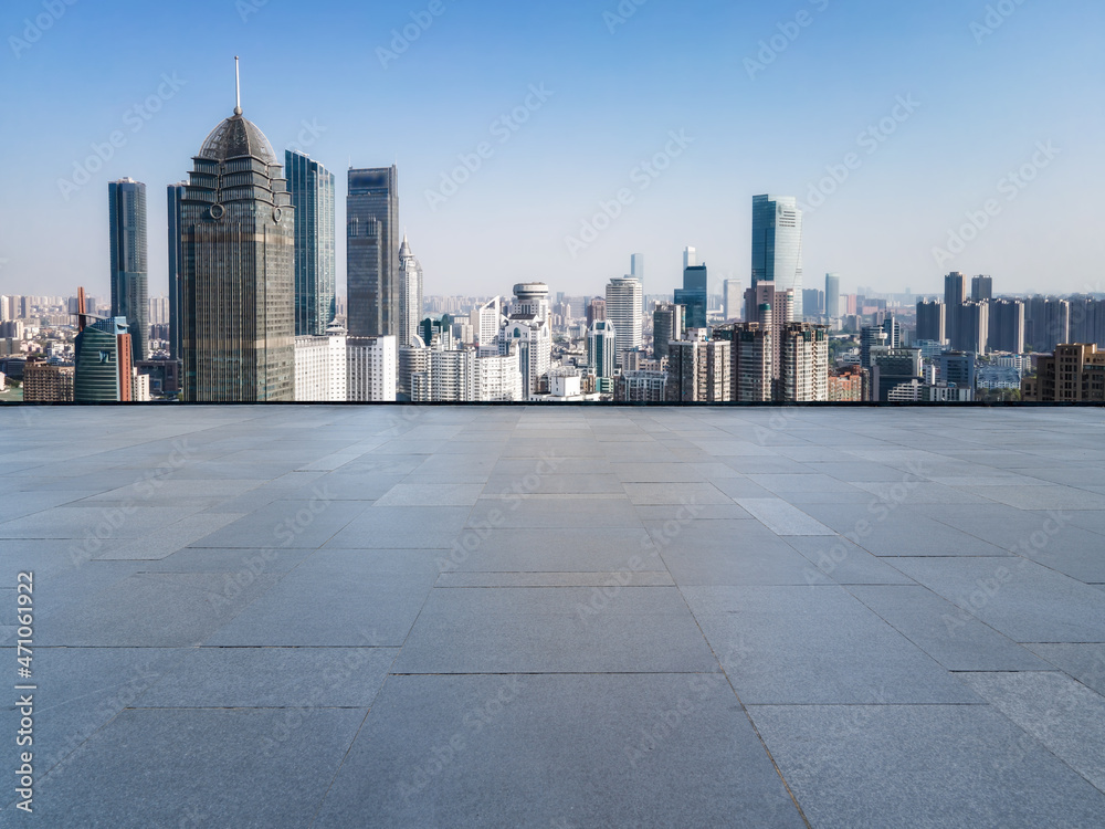 Empty brick floor with city skyline background