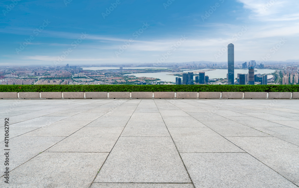 Fototapeta premium Empty brick floor with city skyline background