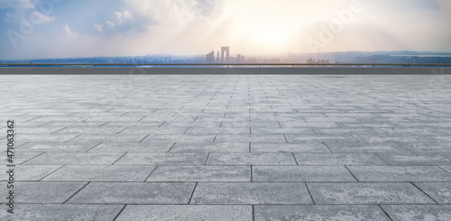 Empty brick floor with city skyline background photo