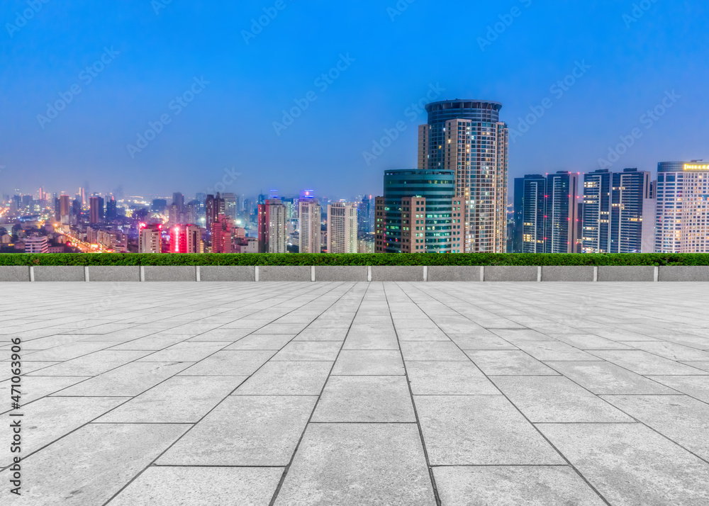 Empty brick floor with city skyline background