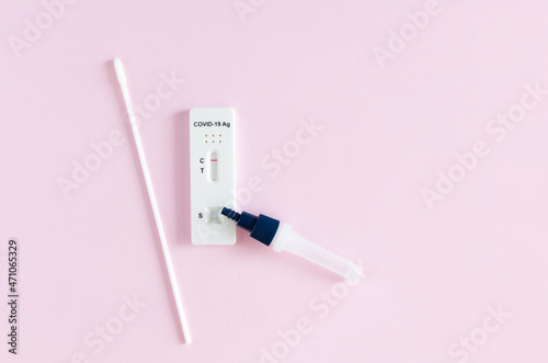 Negative Covid-19 test. Rapid antigen test on pink background. photo