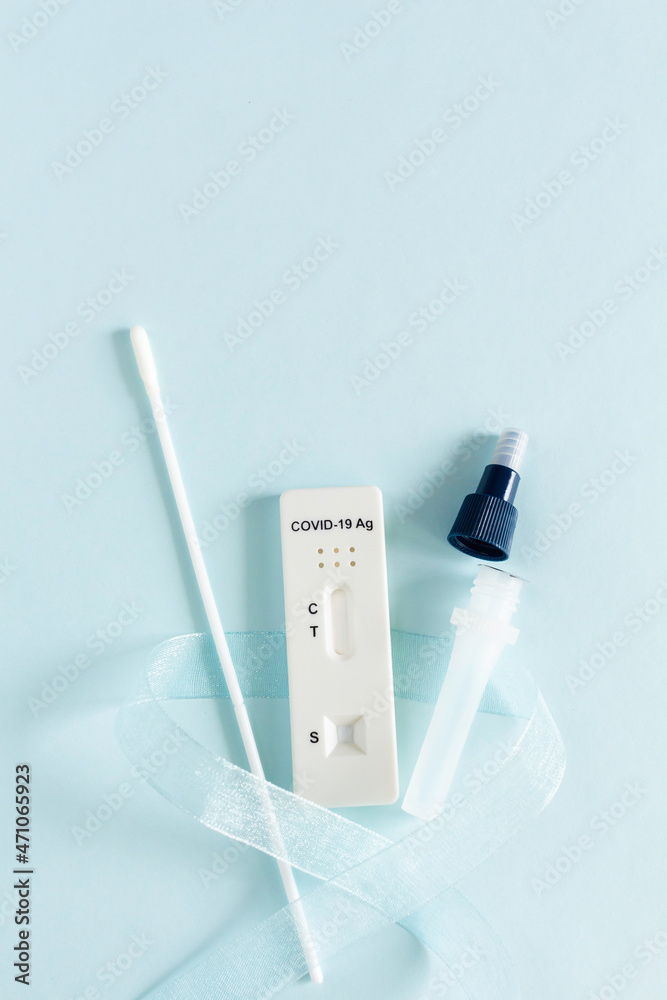 Covid-19 Ag test kit on blue background, close up. Covid-19 Ag test kit on blue background, close up.