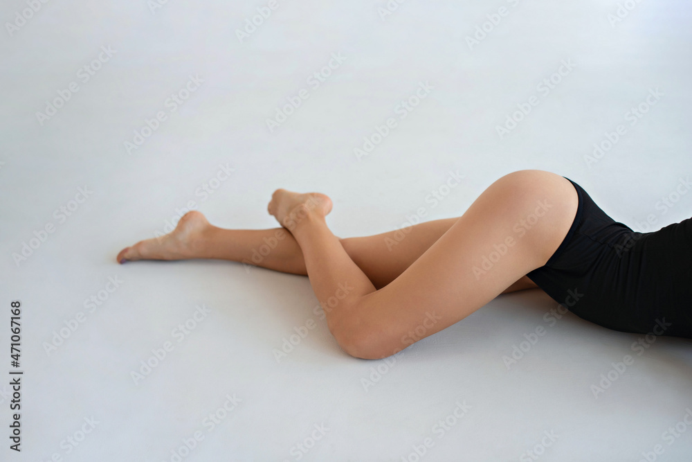 Smooth shapely female legs on a white background. Mockup for a tattoo on the thigh or lower leg. Smooth shapely female legs on a white background. Mockup for a tattoo on the thigh or lower leg.